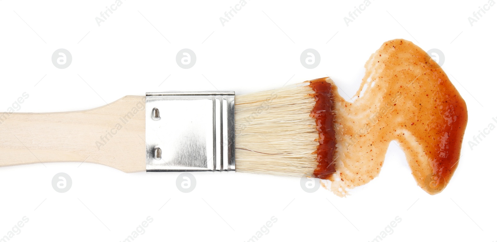 Photo of Marinade with basting brush isolated on white, top view