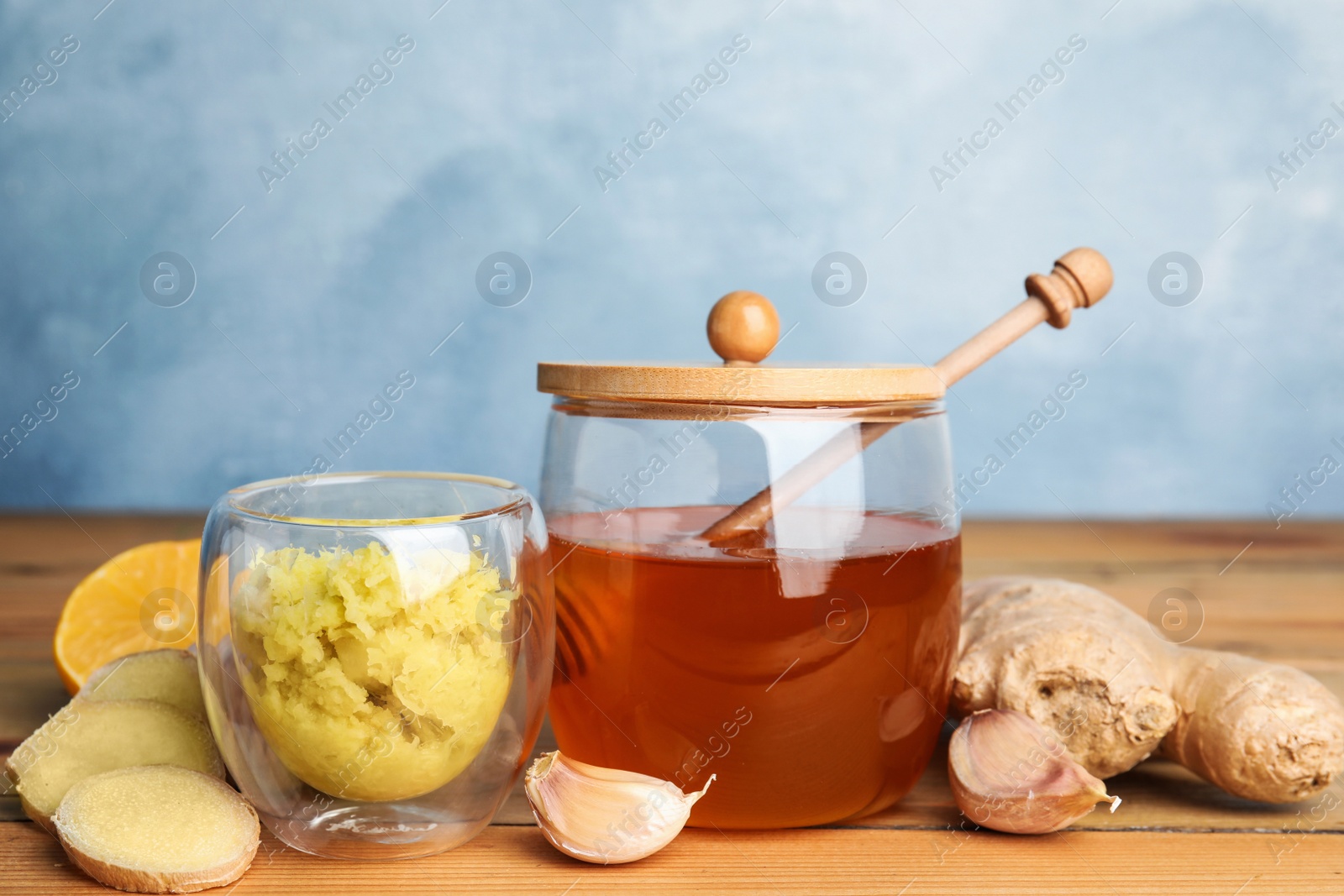 Photo of Fresh garlic and other natural cold remedies on wooden table