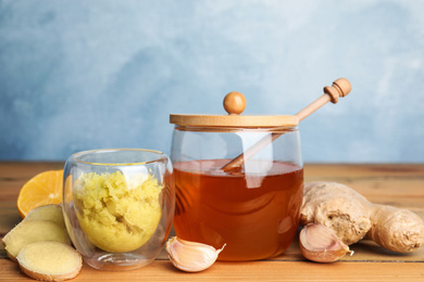 Photo of Fresh garlic and other natural cold remedies on wooden table