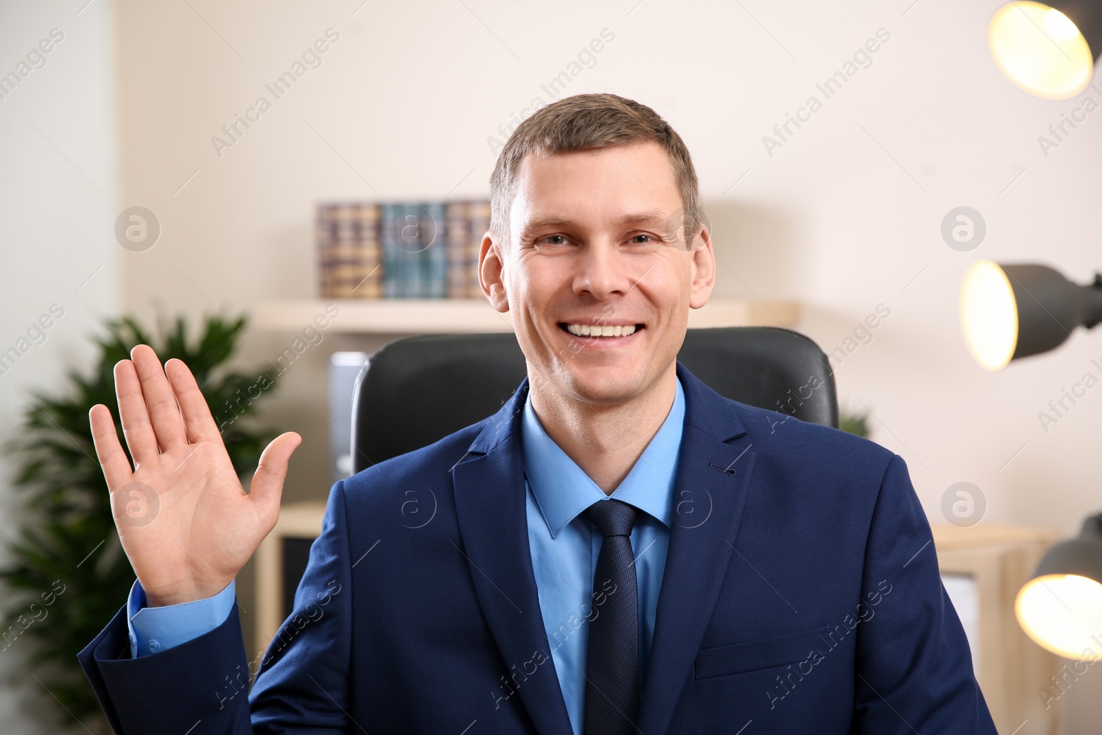 Photo of Man using video chat in office, view from web camera