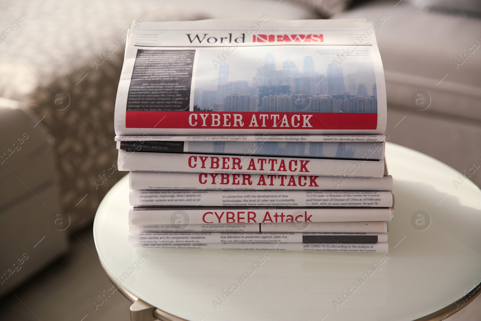 Photo of Stack of newspapers with headlines CYBER ATTACK on table indoors