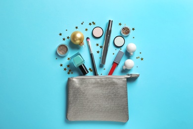 Photo of Flat lay composition with makeup products and Christmas decor on color background