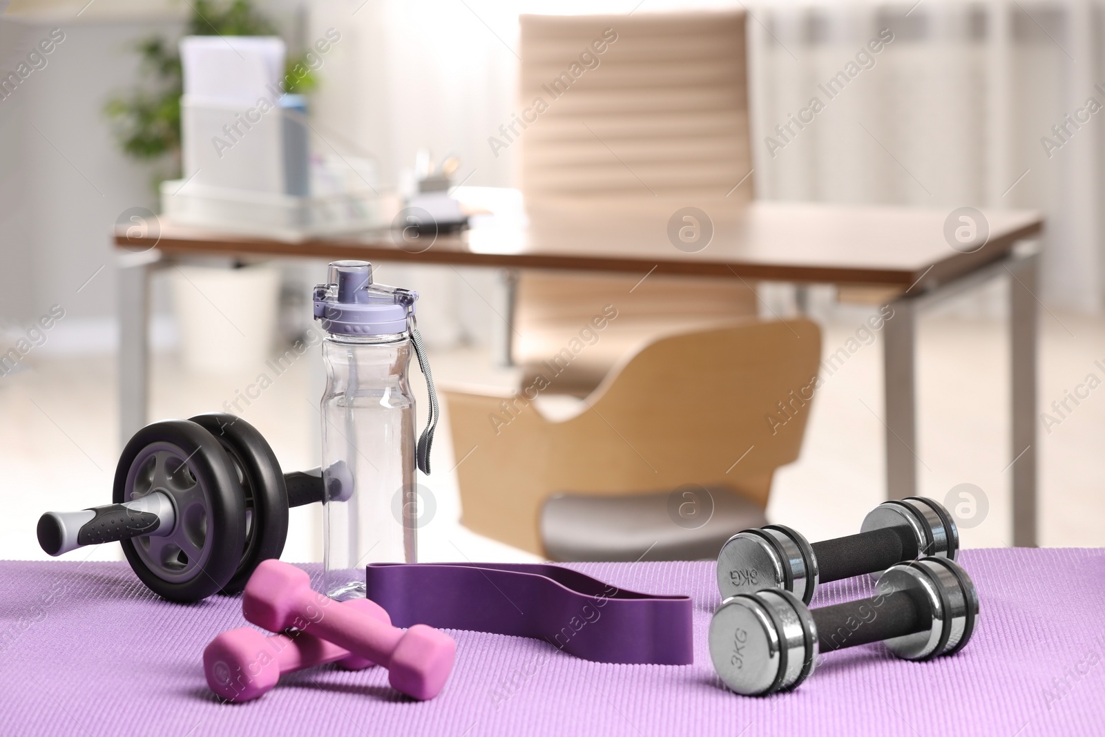 Photo of Many different sports equipment on mat indoors