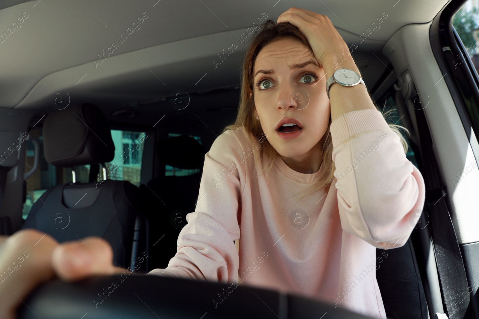 Photo of Stressed woman in driver's seat of modern car