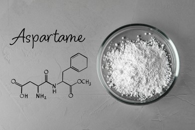 Formula of aspartame (chemical and structural). Artificial sweetener in Petri dish on gray table, top view