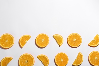 Photo of Flat lay composition with fresh ripe oranges on white background. Space for text
