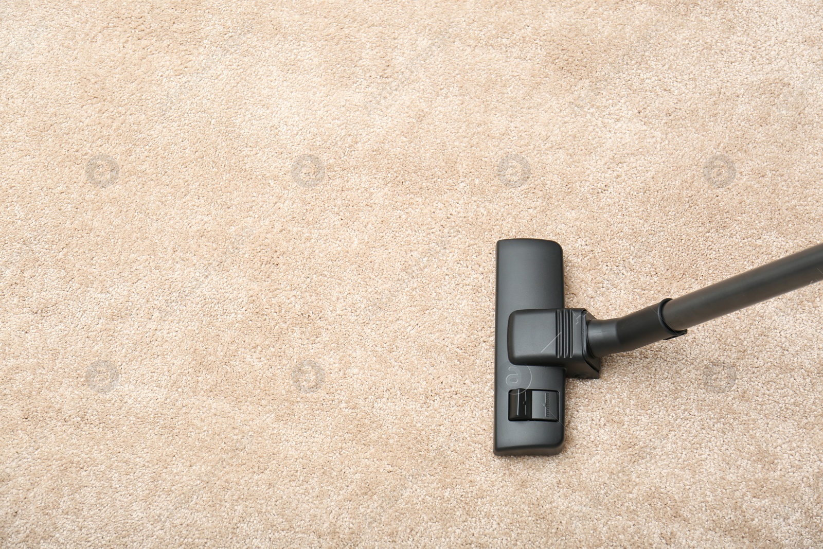 Photo of Removing dirt from carpet with vacuum cleaner indoors, top view. Space for text