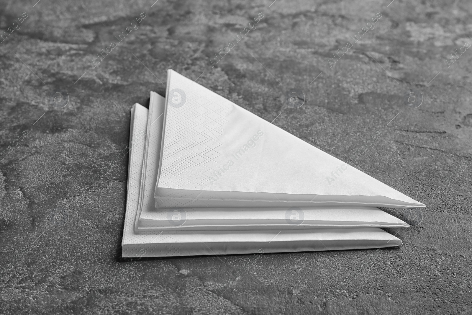 Photo of Clean napkins on grey background. Personal hygiene