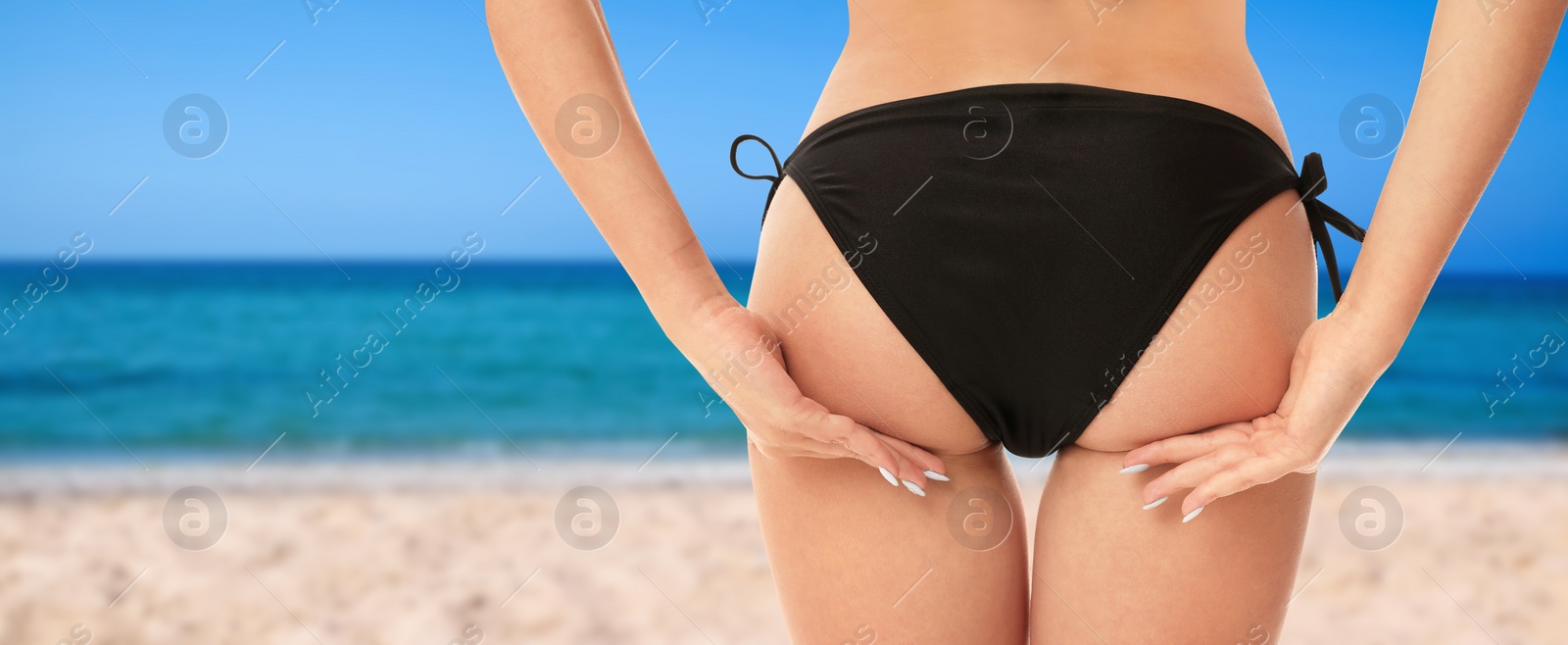 Image of Sexy young woman wearing stylish bikini at beach on sunny day, closeup. Banner design