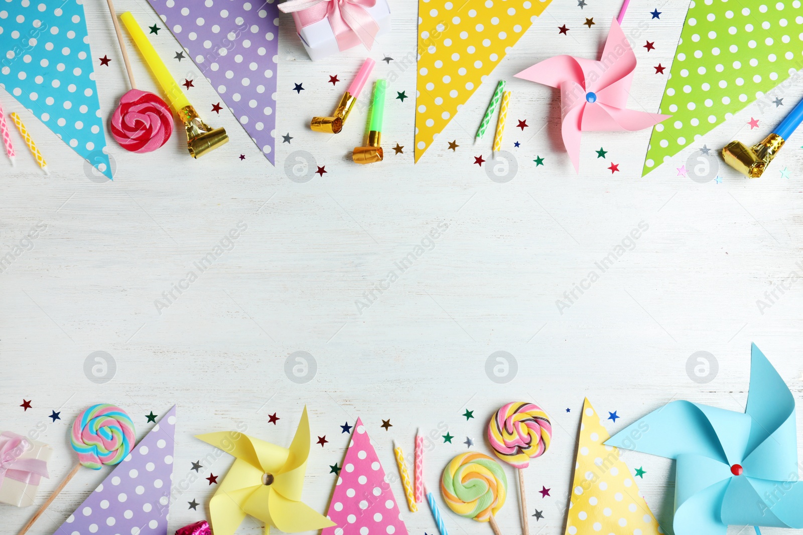 Photo of Colorful birthday accessories on white wooden background, flat lay. Space for text