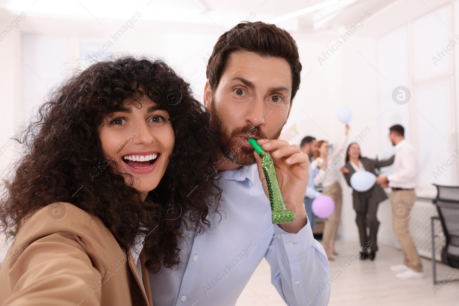 Photo of Coworkers taking selfie during office party indoors, space for text