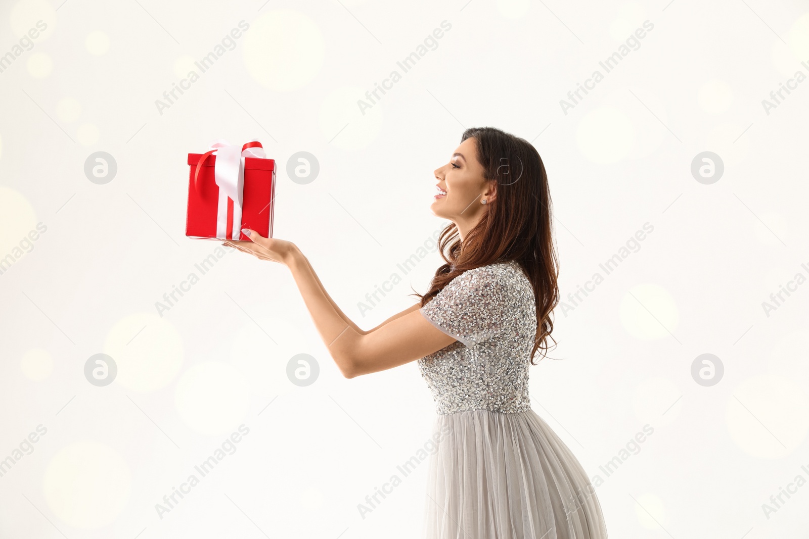 Photo of Beautiful woman with Christmas gift on white background