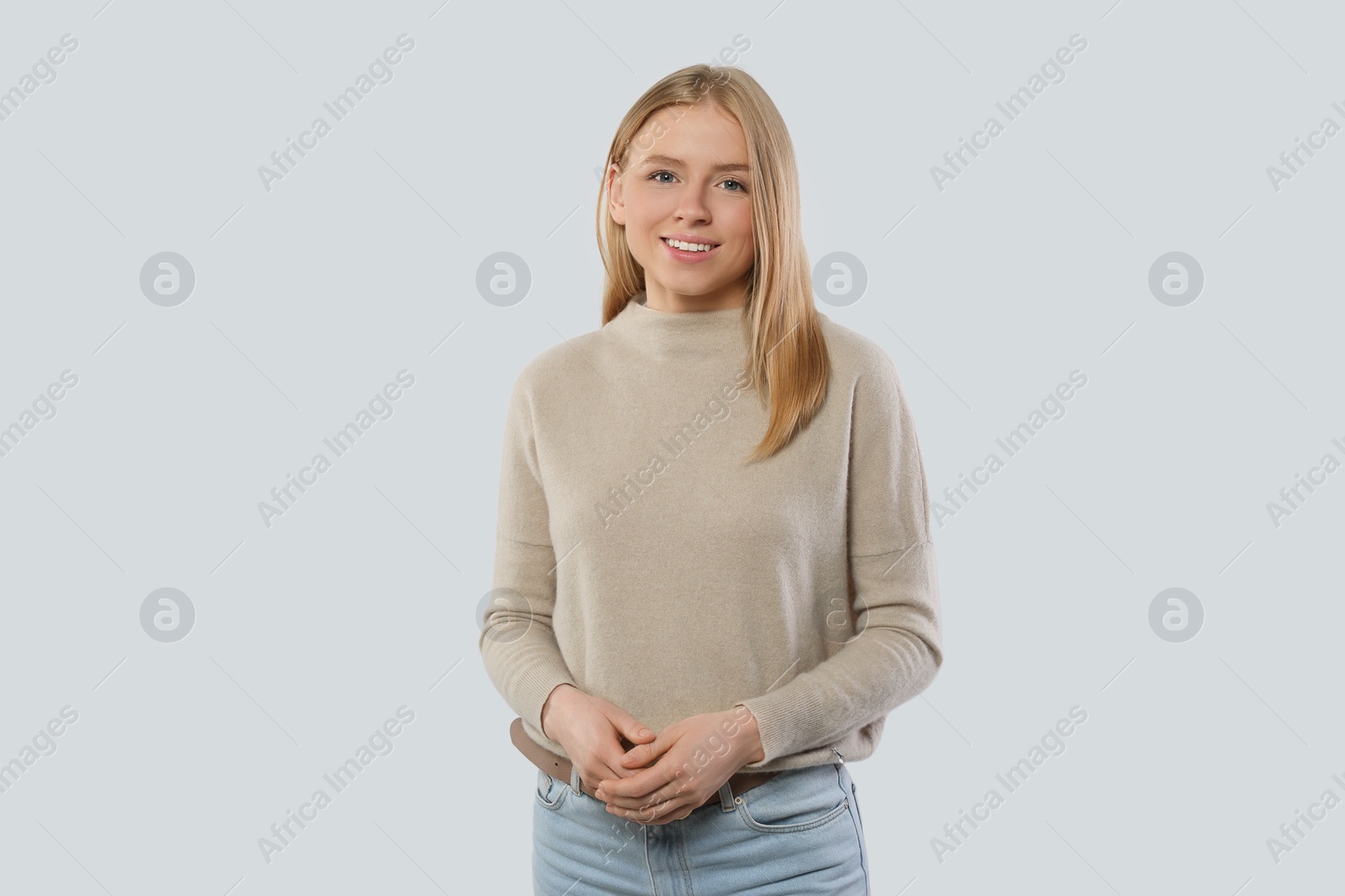 Photo of Portrait of beautiful young woman in stylish sweater on white background