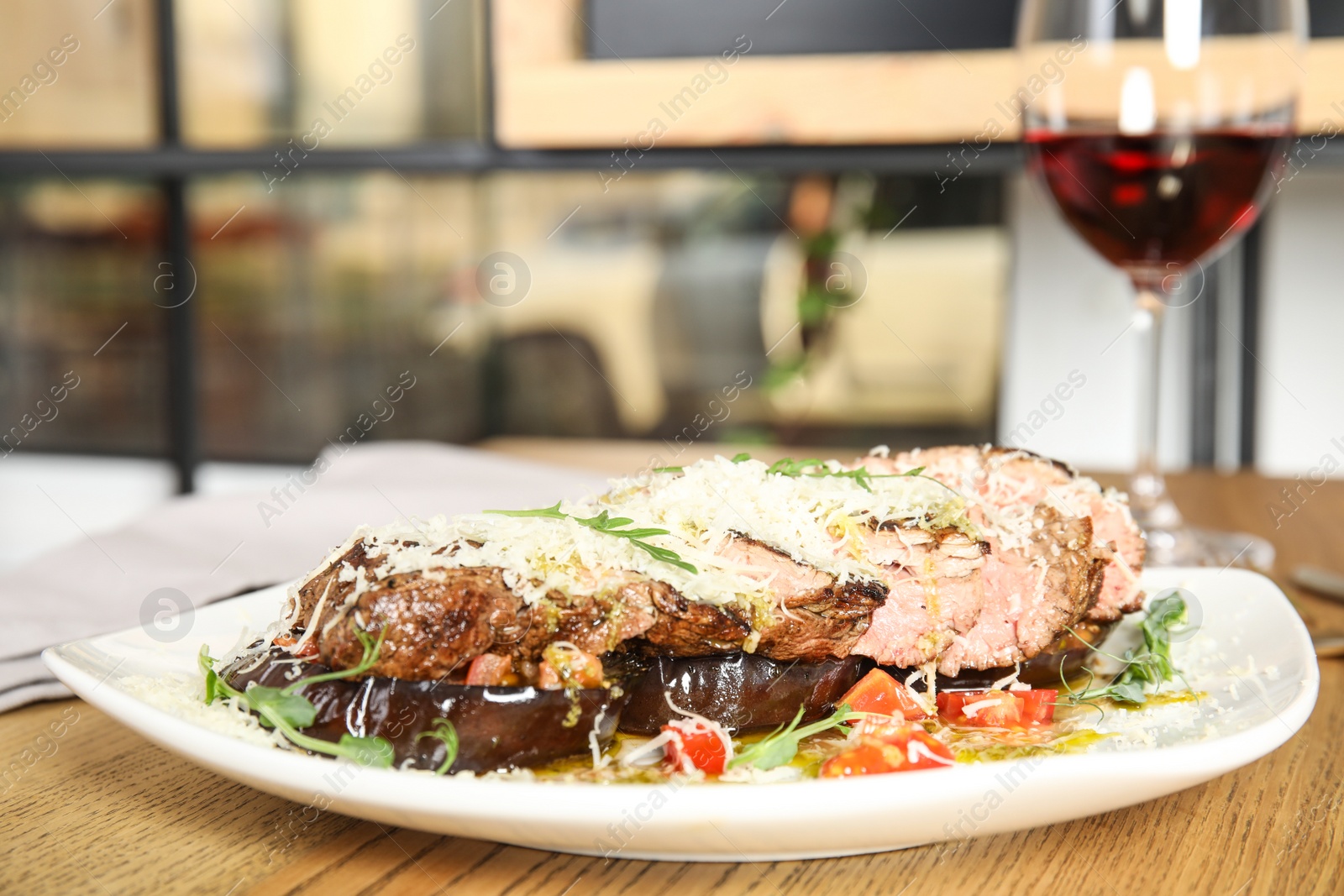 Photo of Delicious roasted meat served on wooden table indoors. Space for text