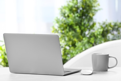 Laptop on desk in home office. Comfortable workplace