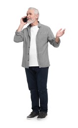 Senior man talking on smartphone against white background