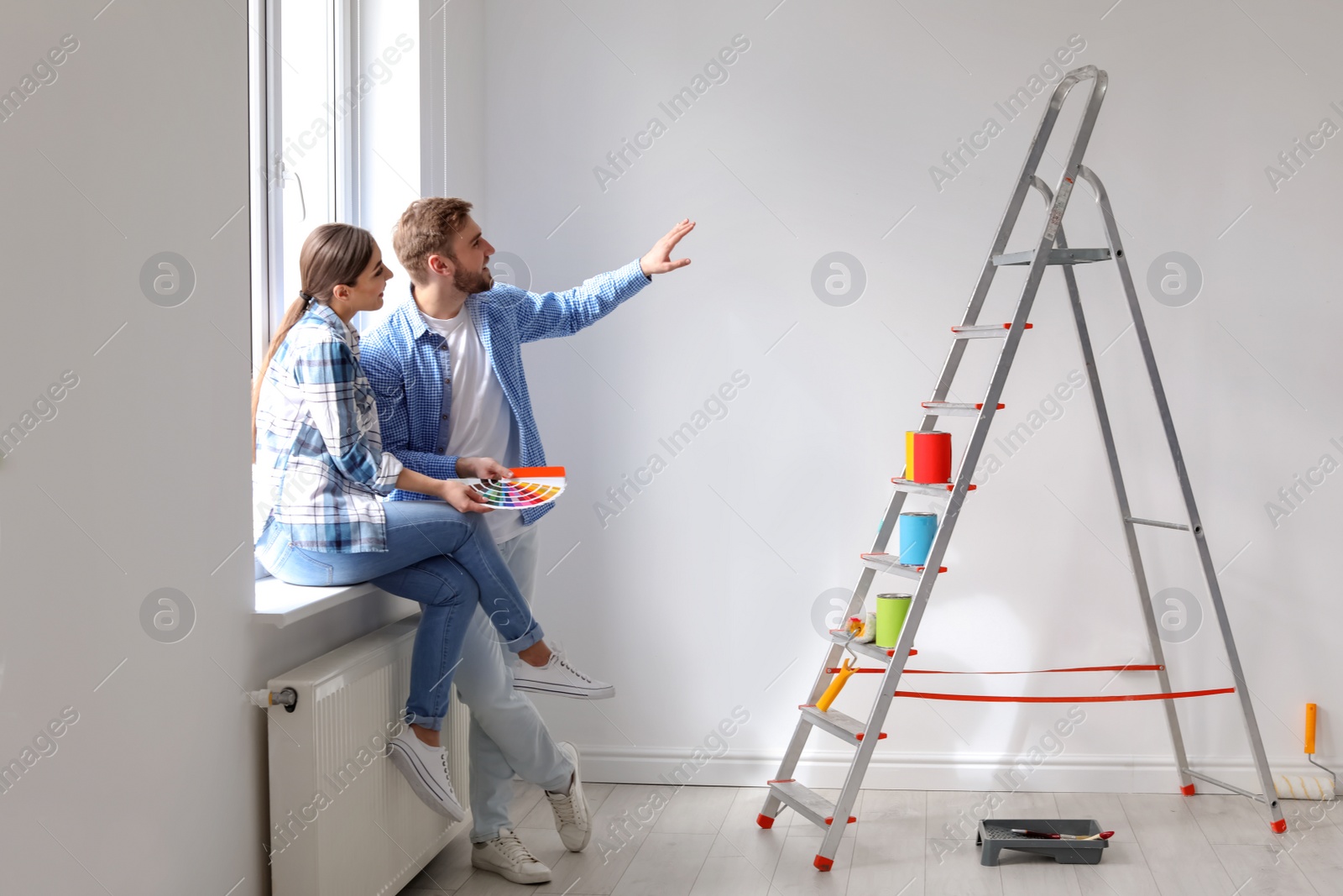 Photo of Young couple with color palette indoors