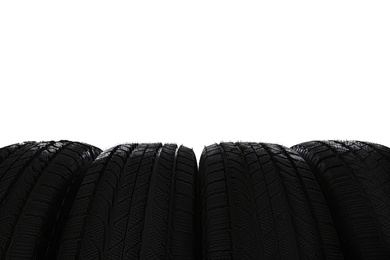 Photo of Set of new winter tires on white background, closeup