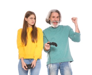 Mature man and young woman playing video games with controllers isolated on white