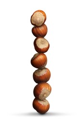 Stack of many hazelnuts on white background