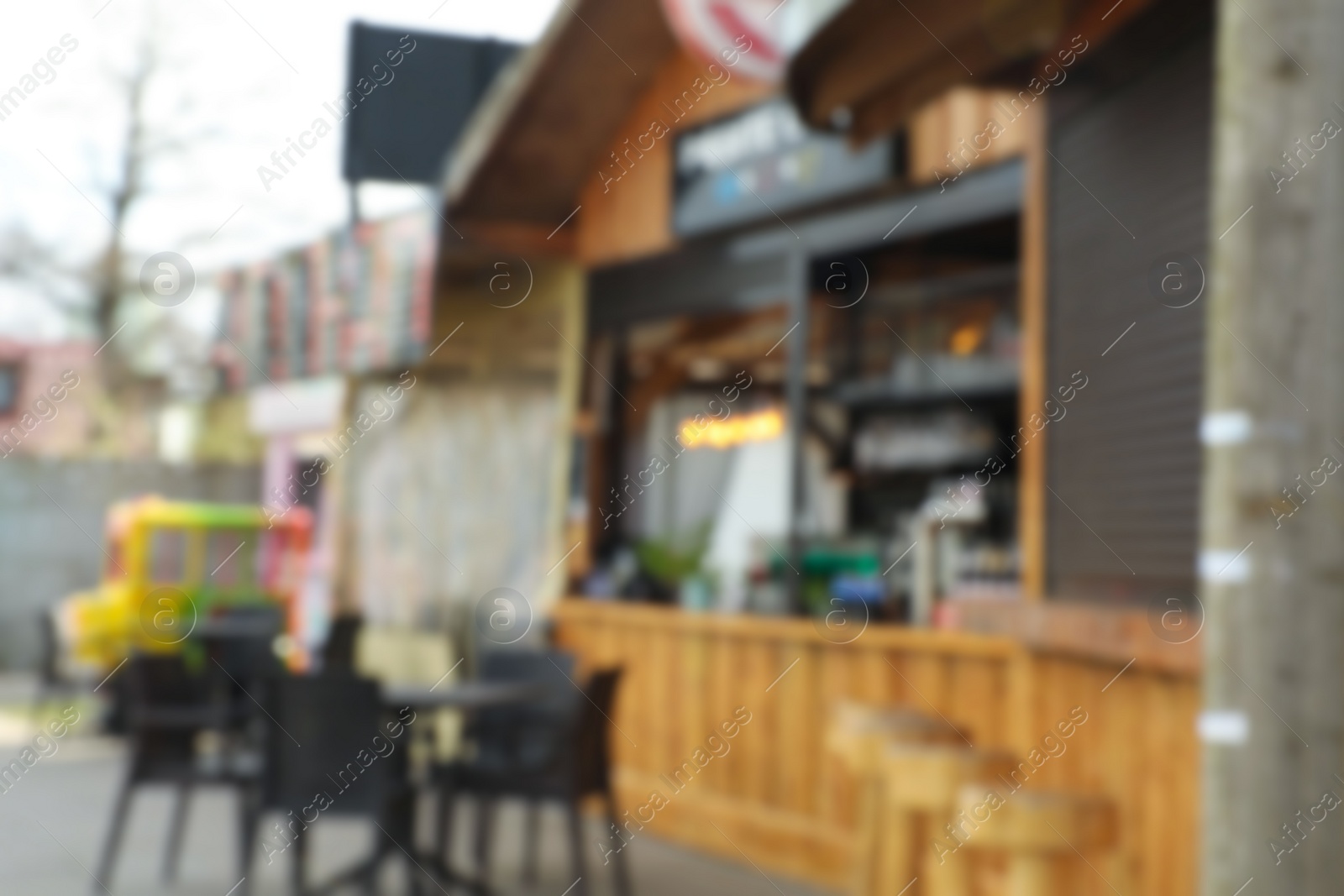 Photo of Blurred view of modern outdoor cafe on city street