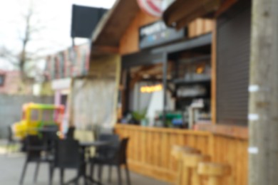 Blurred view of modern outdoor cafe on city street