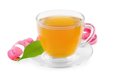 Photo of Glass cup of diet herbal tea, measuring tape and fresh leaf on white background. Weight loss