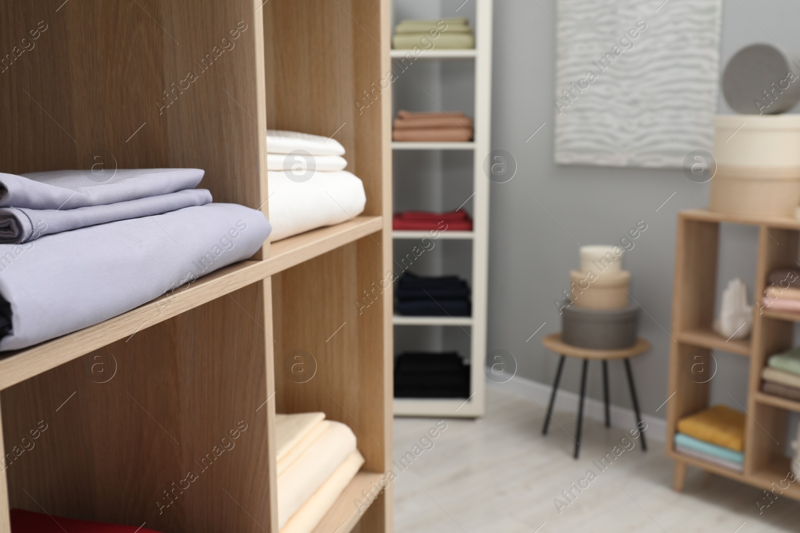 Photo of Different colorful bed linens on display in home textiles store