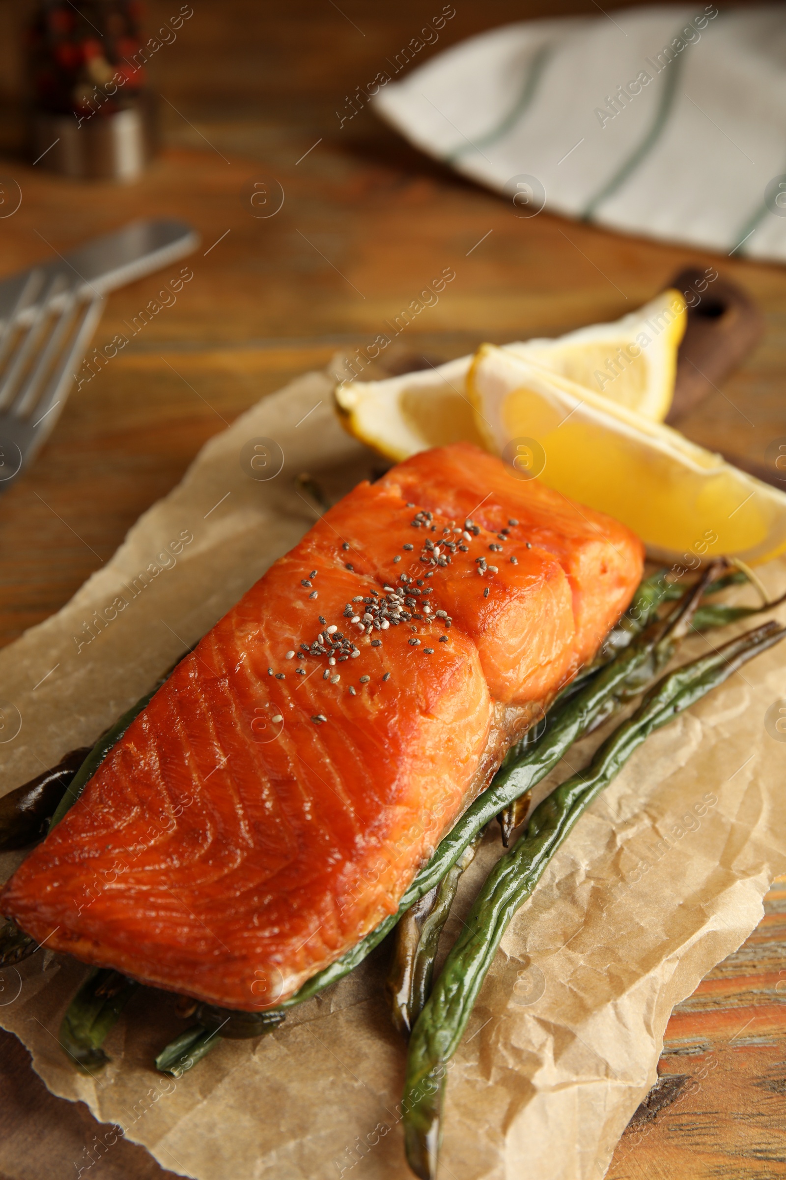 Photo of Tasty cooked salmon and vegetables served on wooden table. Healthy meals from air fryer