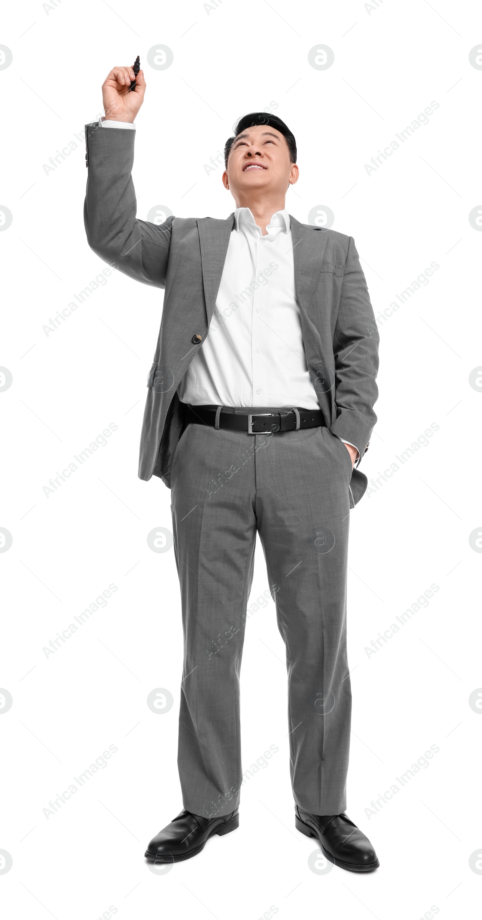 Photo of Businessman in suit with marker writing on white background, low angle view