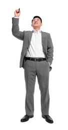 Businessman in suit with marker writing on white background, low angle view