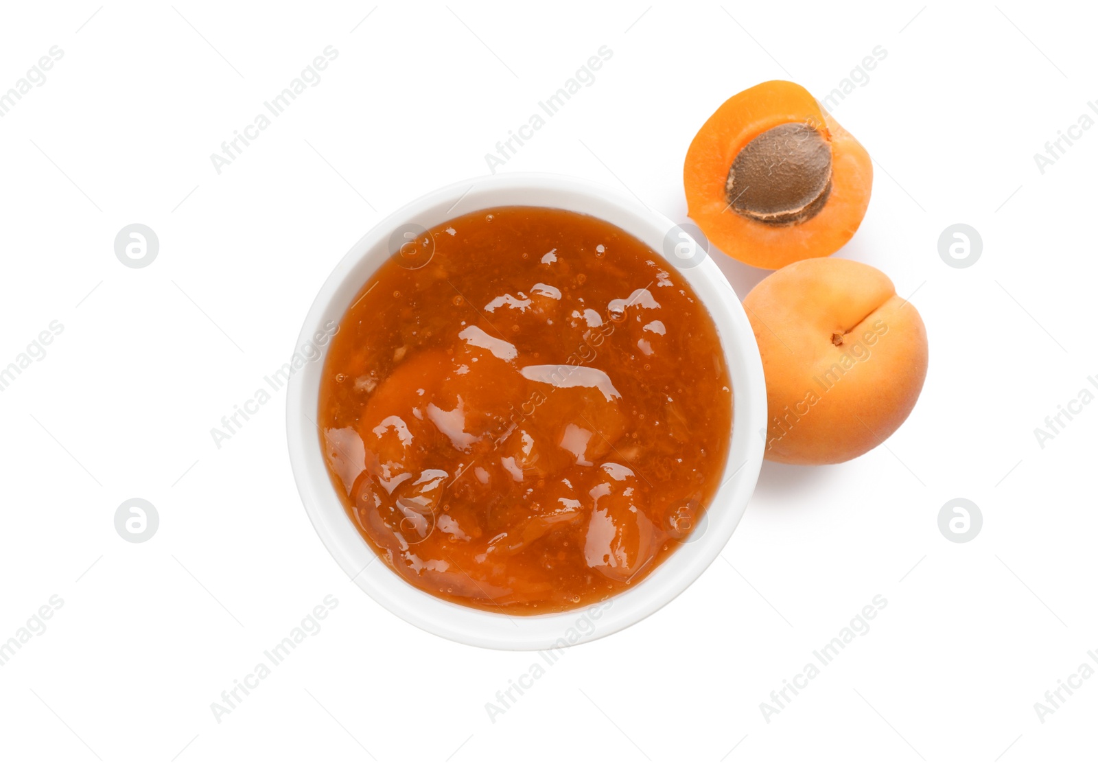 Photo of Jar with delicious apricot jam and fruit on white background