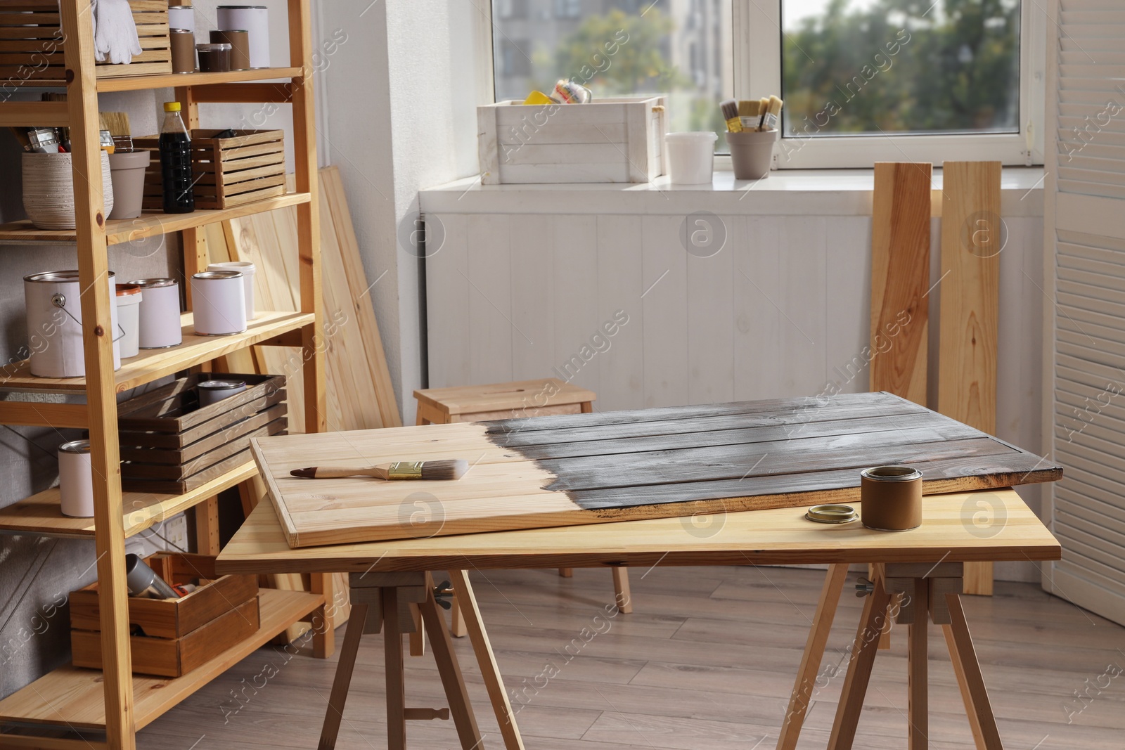 Photo of Applying wood stain. Different equipment in workshop