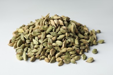 Pile of dry cardamom pods on light table