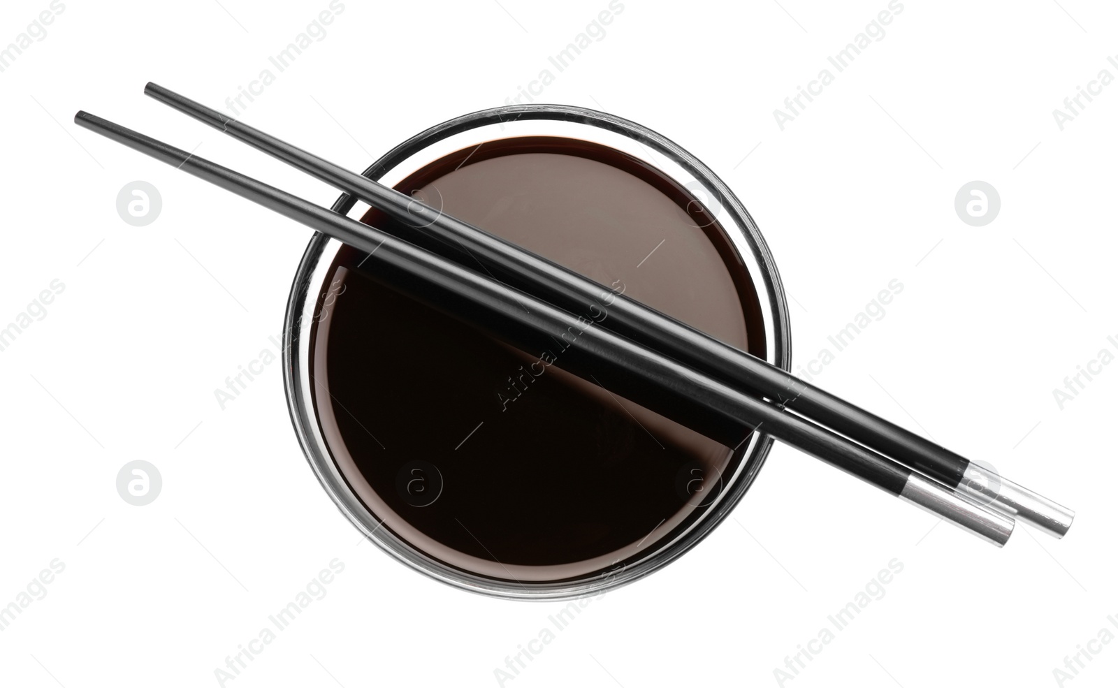 Photo of Bowl of soy sauce with chopsticks on white background, top view