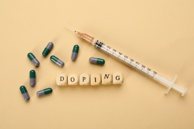 Wooden cubes with word Doping and drugs on beige background, flat lay