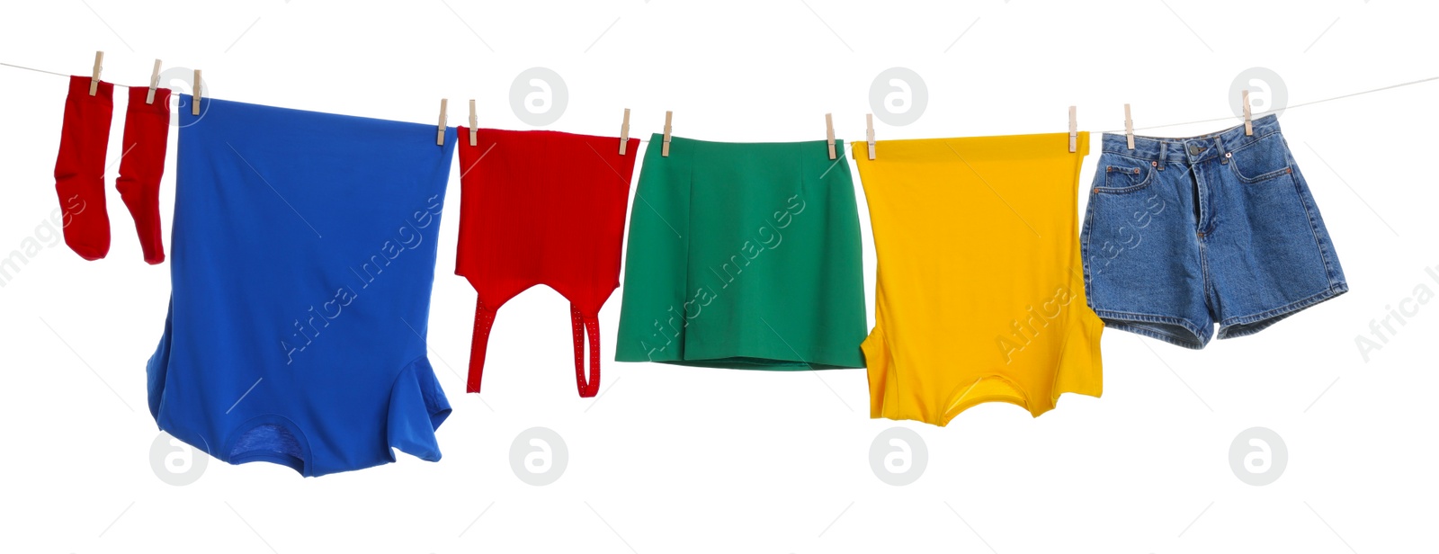 Photo of Different clothes drying on laundry line against white background