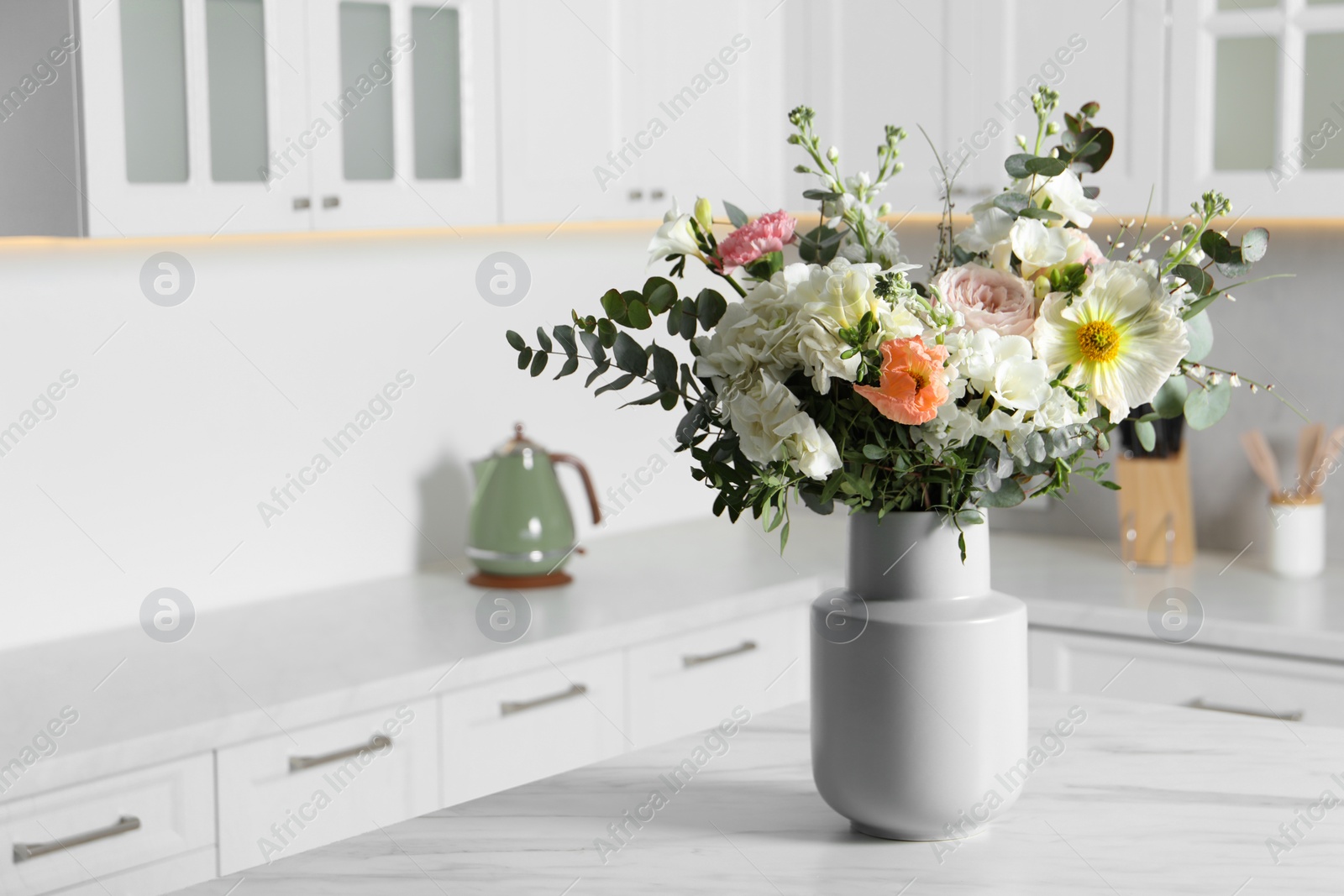 Photo of Bouquet of beautiful flowers on white table indoors. Space for text