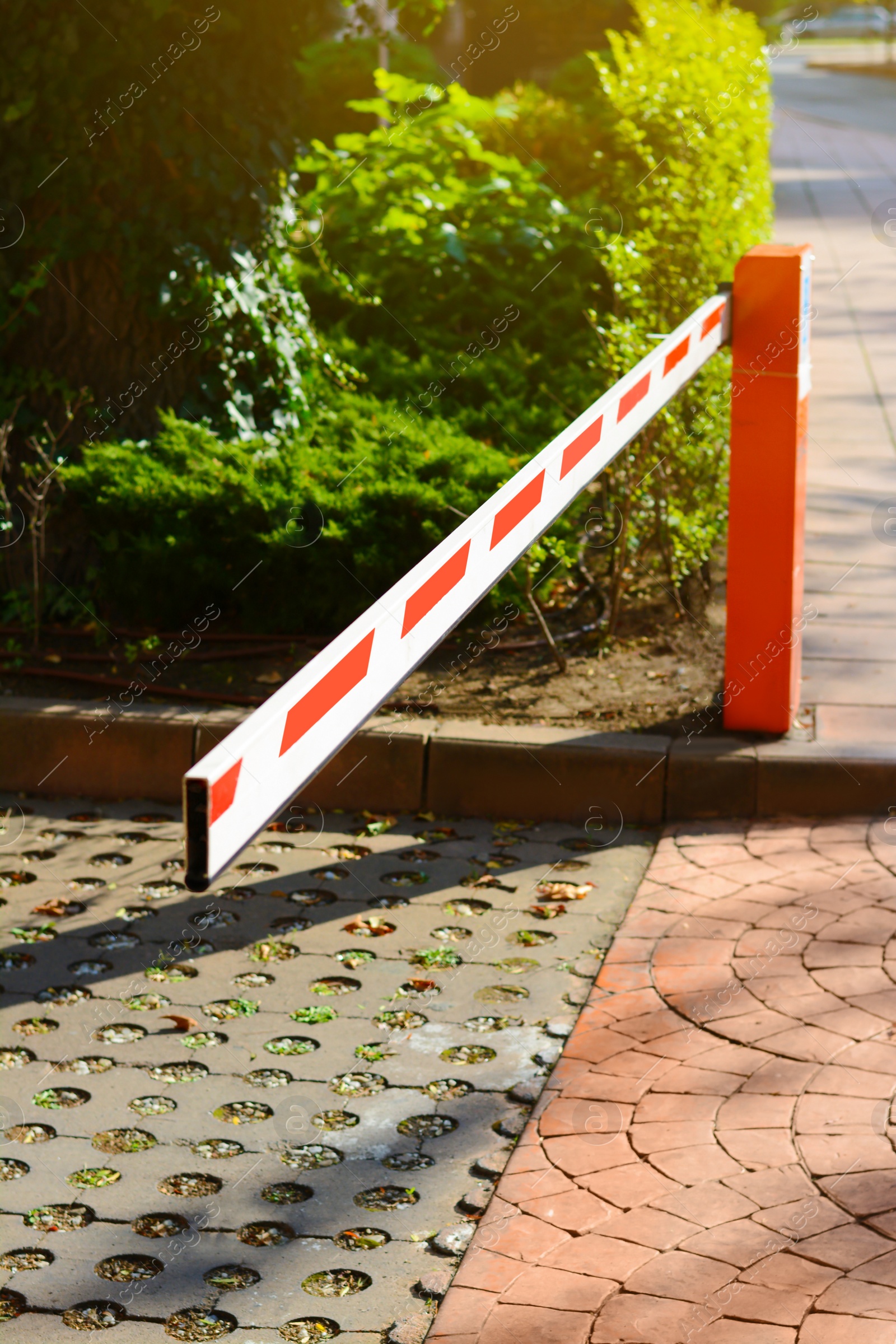 Photo of Closed boom barrier on sunny day outdoors