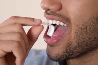 Photo of Man with chewing gum on blurred background, closeup