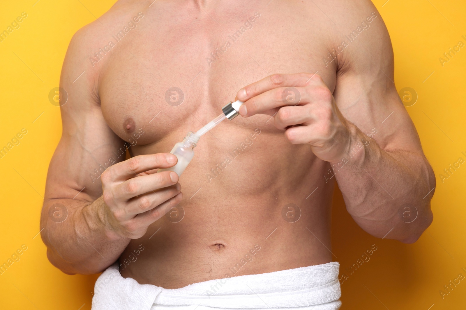 Photo of Man with serum on orange background, closeup