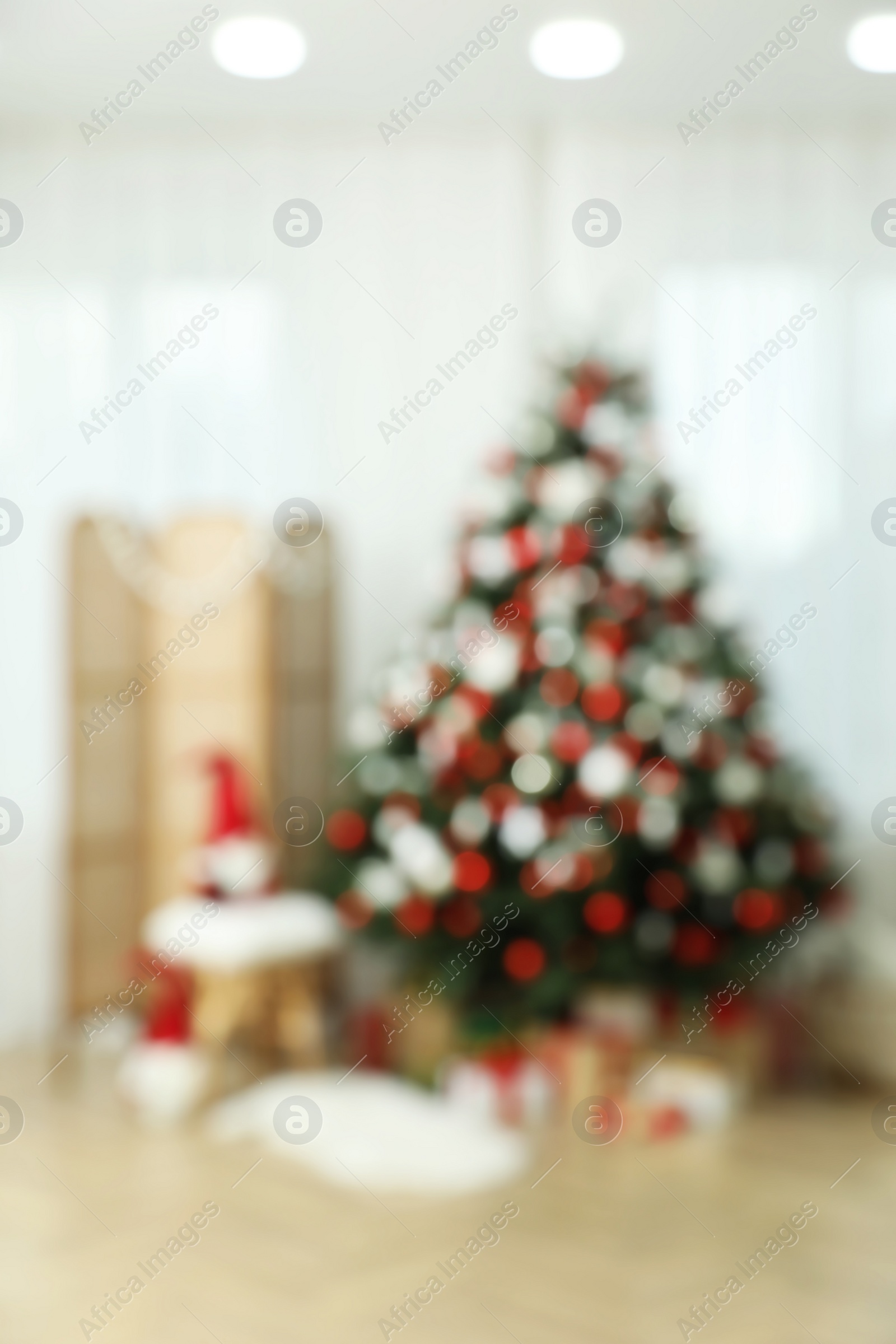Photo of Blurred view of room interior with beautifully decorated Christmas tree