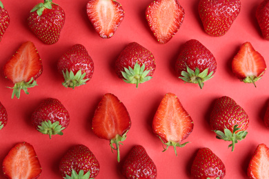 Photo of Tasty ripe strawberries on red background, flat lay