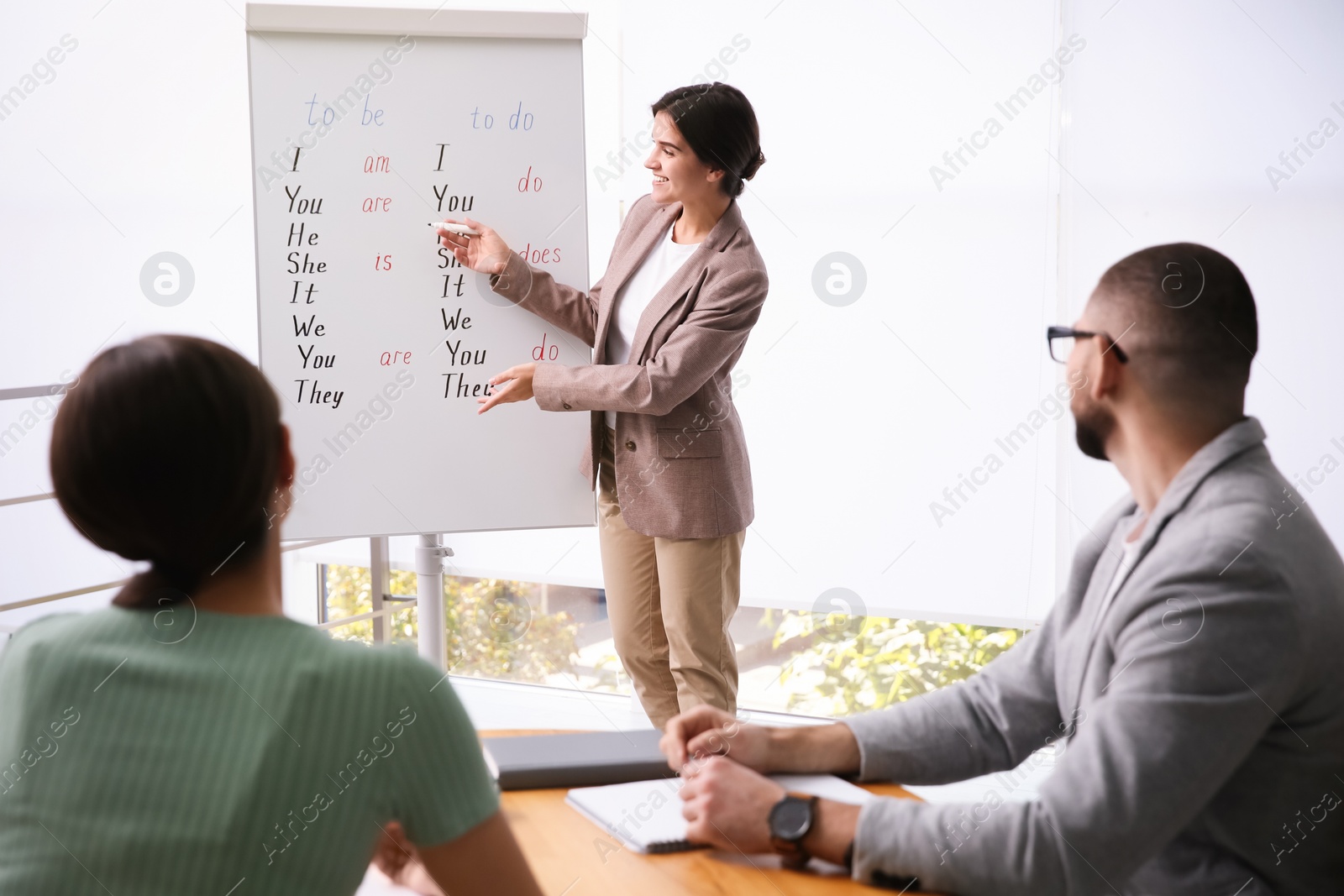 Photo of English teacher with students in class at lesson