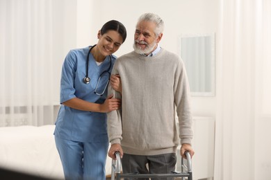 Health care and support. Smiling nurse with elderly patient in hospital