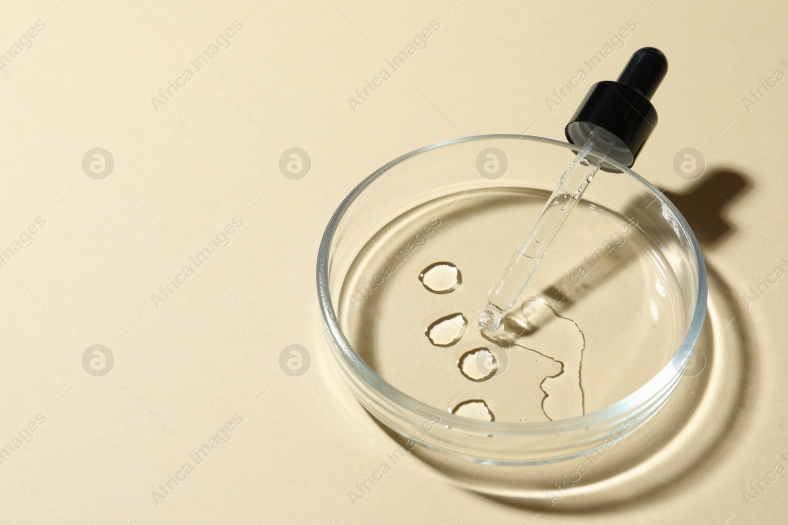 Photo of Petri dish and cosmetic product on beige background, closeup. Space for text