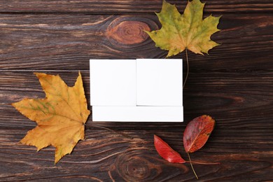 Photo of Thanksgiving day, holiday celebrated every fourth Thursday in November. Block calendar and autumn leaves on wooden table, flat lay