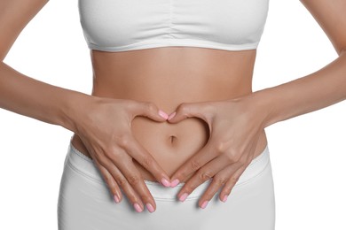 Photo of Woman in underwear making heart with hands on her belly near white background, closeup. Healthy stomach