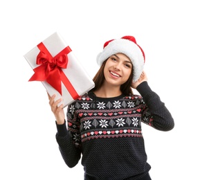 Young beautiful woman in Santa hat with gift box on white background. Christmas celebration