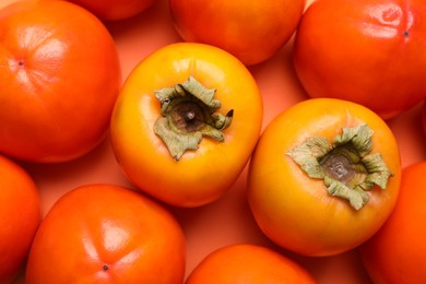 Delicious ripe juicy persimmons as background, top view